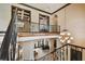 View of the foyer from the stairway, showcasing the grand chandelier at 17005 Madres De Avila, Tampa, FL 33613