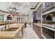 Beautiful kitchen featuring a large island, stainless steel appliances, custom cabinetry, and granite countertops at 17005 Madres De Avila, Tampa, FL 33613