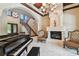 Elegant formal living room featuring marble floors, a fireplace, and a grand piano at 17005 Madres De Avila, Tampa, FL 33613