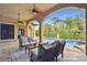 Covered outdoor living area with patio furniture overlooking the pool at 17005 Madres De Avila, Tampa, FL 33613