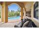 Covered outdoor living area with patio furniture overlooking the pool and backyard at 17005 Madres De Avila, Tampa, FL 33613