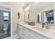 This bathroom features dual sinks, white cabinets, and stylish lighting at 1887 Oak Forest E Dr, Clearwater, FL 33759