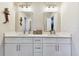 Bright bathroom featuring dual sinks with white cabinetry and tasteful decor at 1887 Oak Forest E Dr, Clearwater, FL 33759