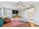 Bedroom with hardwood floors, large flat screen tv, and en suite bathroom with sliding barn door at 1887 Oak Forest E Dr, Clearwater, FL 33759
