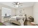 Bright bedroom features neutral walls, plush carpet, a ceiling fan and decoratively adorned with tasteful accents at 1887 Oak Forest E Dr, Clearwater, FL 33759