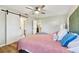 Brightly lit bedroom with plank flooring, sliding barn door and en suite bathroom at 1887 Oak Forest E Dr, Clearwater, FL 33759