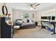Cozy bedroom with a comfortable daybed, ample natural light, and a functional workspace at 1887 Oak Forest E Dr, Clearwater, FL 33759