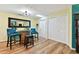 Cozy dining area features unique barrel table, stylish chairs, and a decorative mirror at 1887 Oak Forest E Dr, Clearwater, FL 33759