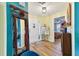 Inviting home entryway featuring hardwood floors and an eclectically framed mirror adjacent to the front door at 1887 Oak Forest E Dr, Clearwater, FL 33759