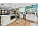 Well-lit kitchen featuring stainless steel appliances, tile backsplash, and modern pendant lighting at 1887 Oak Forest E Dr, Clearwater, FL 33759