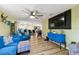 Open-concept living room with sleek furnishings, modern lighting, and seamless flow to kitchen at 1887 Oak Forest E Dr, Clearwater, FL 33759