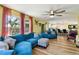 Spacious living room featuring plush sectional, large windows, and an open floor plan at 1887 Oak Forest E Dr, Clearwater, FL 33759