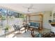 Covered patio with comfortable seating and ceiling fan, ideal for outdoor relaxation and entertaining at 1887 Oak Forest E Dr, Clearwater, FL 33759