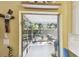 Enclosed patio featuring a rocking chair and views of the backyard, perfect for relaxing in comfort at 1887 Oak Forest E Dr, Clearwater, FL 33759