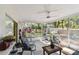 Covered patio with comfortable seating, and views of the fenced backyard, providing an inviting outdoor space at 1887 Oak Forest E Dr, Clearwater, FL 33759
