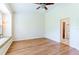 Bedroom featuring wood floors, ceiling fan, and a window seat nook at 19200 Weymouth Dr, Land O Lakes, FL 34638