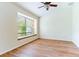 Bright bedroom with wood floors, ceiling fan and a window seat at 19200 Weymouth Dr, Land O Lakes, FL 34638