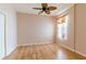 Bedroom features wood floors, ceiling fan, and natural light at 19200 Weymouth Dr, Land O Lakes, FL 34638