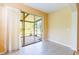 Cozy Florida room with tile flooring and sliding glass doors to the exterior at 19200 Weymouth Dr, Land O Lakes, FL 34638