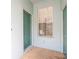 A green front door and a window with blinds on a light blue exterior at 19200 Weymouth Dr, Land O Lakes, FL 34638