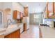 Bright kitchen area featuring tile floors, wooden cabinets, and modern appliances at 19200 Weymouth Dr, Land O Lakes, FL 34638