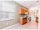 Open kitchen features tile flooring, light countertops, and white appliances at 19200 Weymouth Dr, Land O Lakes, FL 34638