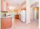 Open kitchen with tile flooring, light countertops, and white appliances at 19200 Weymouth Dr, Land O Lakes, FL 34638