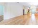 Open living space with hardwood floors and a view of the kitchen at 19200 Weymouth Dr, Land O Lakes, FL 34638