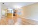 Spacious living room open to the kitchen with wood floors and natural light at 19200 Weymouth Dr, Land O Lakes, FL 34638