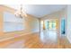 Open floor plan featuring wood floors, chandelier, and sliding glass doors at 19200 Weymouth Dr, Land O Lakes, FL 34638