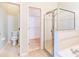 Open concept main bathroom with walk-in closet, glass shower, and water closet at 19200 Weymouth Dr, Land O Lakes, FL 34638