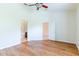 A large, bright main bedroom features wood floors and entry to the en suite bathroom at 19200 Weymouth Dr, Land O Lakes, FL 34638