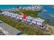 High aerial shot of waterfront homes featuring metal roofs, set near a scenic waterway with coastal views at 19829 Gulf Blvd # 601, Indian Shores, FL 33785