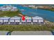 Expansive aerial shot of new waterfront constructions with metal roof set against a scenic waterway backdrop at 19829 Gulf Blvd # 601, Indian Shores, FL 33785
