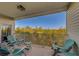 Spacious balcony with seating and view of the surrounding trees and landscaping at 19829 Gulf Blvd # 601, Indian Shores, FL 33785