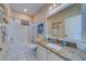 Well-lit bathroom featuring granite countertop, white cabinetry, and shower-tub combination at 19829 Gulf Blvd # 601, Indian Shores, FL 33785