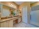 Bathroom featuring double sinks, granite countertops, and a glass-enclosed shower at 19829 Gulf Blvd # 601, Indian Shores, FL 33785
