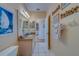 Bright bathroom with granite countertop, white cabinets and beach themed decor at 19829 Gulf Blvd # 601, Indian Shores, FL 33785