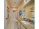 Well-lit bathroom featuring granite countertop, white cabinetry, and shower-tub combination at 19829 Gulf Blvd # 601, Indian Shores, FL 33785