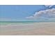 A beautiful tranquil beach with soft sand and gentle waves under a sunny sky at 19829 Gulf Blvd # 601, Indian Shores, FL 33785