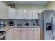 Updated kitchen with stainless steel appliances, granite countertops, and modern backsplash at 19829 Gulf Blvd # 601, Indian Shores, FL 33785