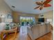 Cozy living room featuring comfortable couches, ceiling fan, and access to a balcony at 19829 Gulf Blvd # 601, Indian Shores, FL 33785