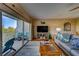 Bright living room with balcony access featuring comfortable seating and stylish coastal decor at 19829 Gulf Blvd # 601, Indian Shores, FL 33785