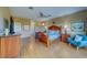 Airy primary bedroom with wood floors, ceiling fan, large bed, and access to ensuite bath at 19829 Gulf Blvd # 601, Indian Shores, FL 33785