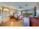 Spacious main bedroom with a large window, ceiling fan, and beautiful wood floors at 19829 Gulf Blvd # 601, Indian Shores, FL 33785