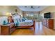 Spacious main bedroom with a large bed, hardwood floors, and lots of natural light at 19829 Gulf Blvd # 601, Indian Shores, FL 33785