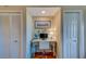 Cozy office space with a desk and chair in a nook between two closet doors at 19829 Gulf Blvd # 601, Indian Shores, FL 33785