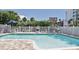 Outdoor pool with lounge chairs and view of a local market at 19829 Gulf Blvd # 601, Indian Shores, FL 33785