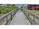 A wood and concrete path leads through the grassy dunes to the beach at 19829 Gulf Blvd # 601, Indian Shores, FL 33785