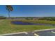 Scenic waterfront view with a small pond on the shore and a dock, perfect for enjoying the outdoors at 19829 Gulf Blvd # 601, Indian Shores, FL 33785